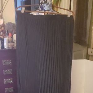 Long black pleated skirt.